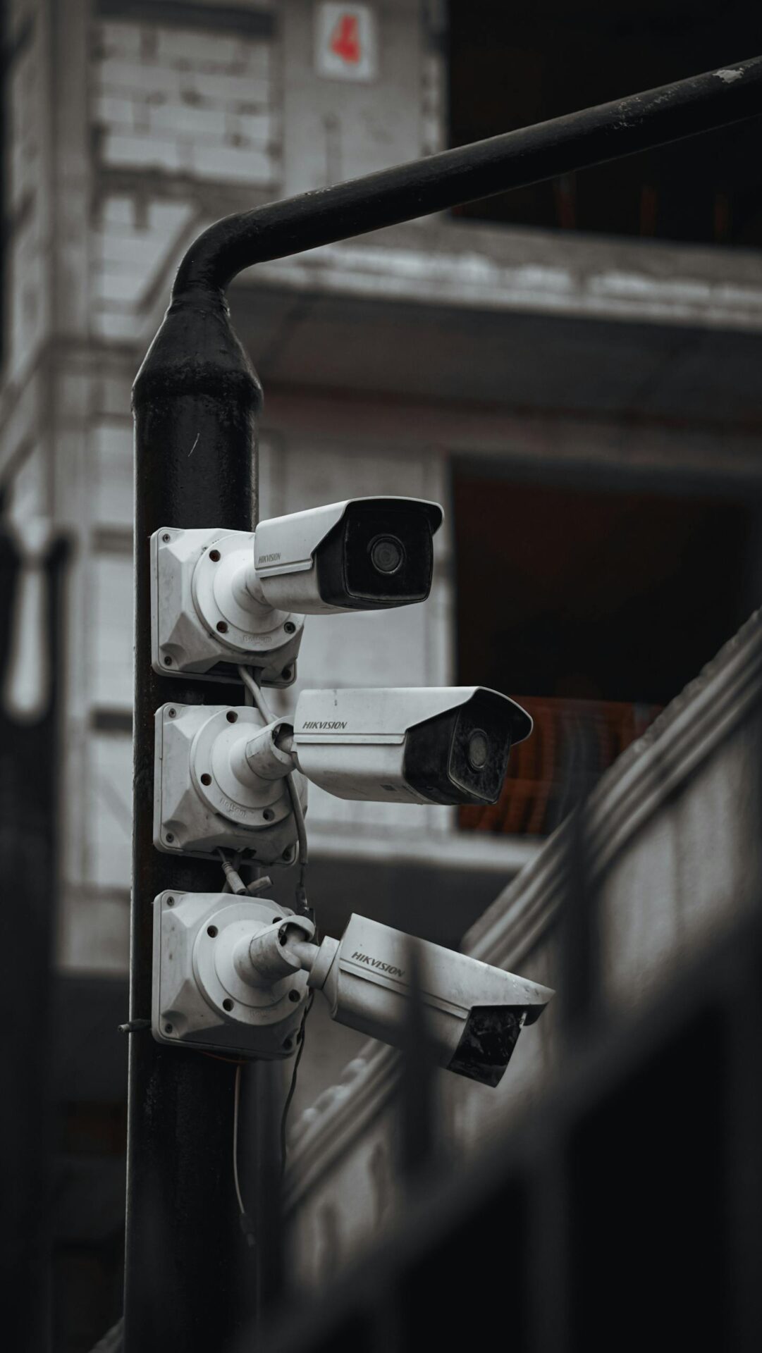 Array of security cameras on a building post, highlighting surveillance and urban security.